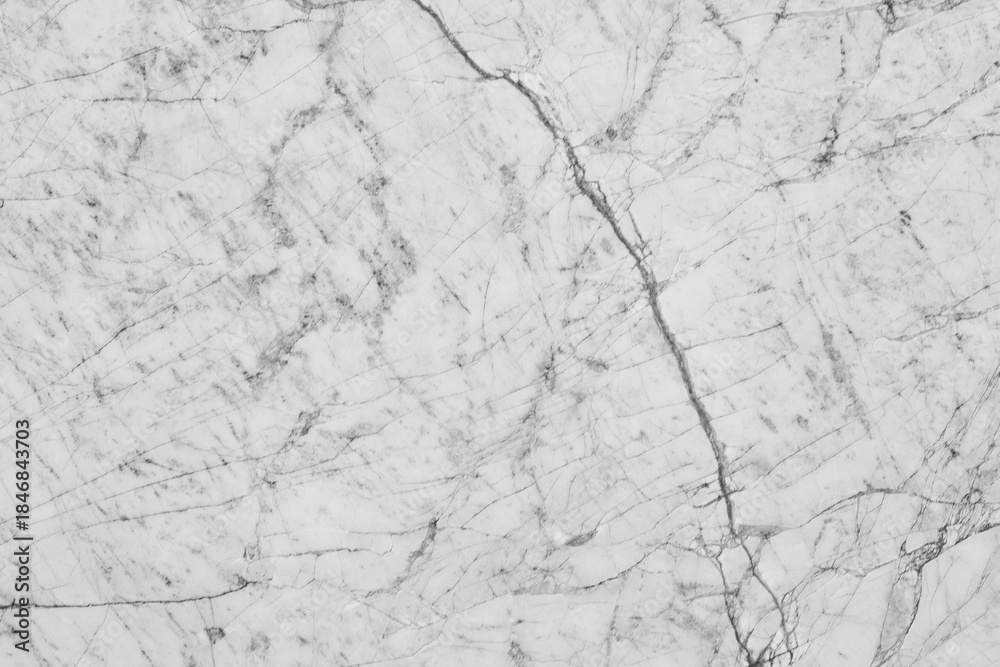 Obraz premium Clean white marble stone texture with sharp branch-like black veins and a fractured natural pattern, perfect for minimalist interior design and high-end bathroom surfaces.