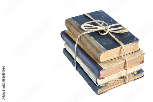 Isolated old books tied with string on white background, ancient books in pile, copy space 