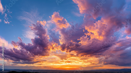 Dramatic beautiful sky with orange, gold, and purple cloud at sunset or sunrise. sun light illuminates horizon creating truly majestic and peaceful nature view
