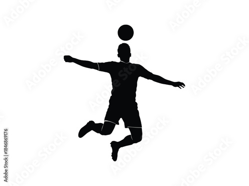 Silhouette of an athlete skillfully heading a soccer ball in mid air