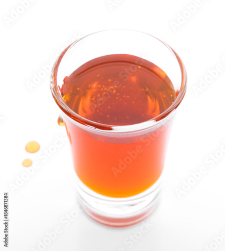 glass of Honey isolated on white background.