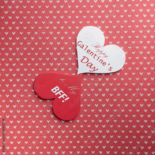 Happy Galentine's Day to my BFF message on a red and a white heart shape. Celebrating best friends on February 13th.