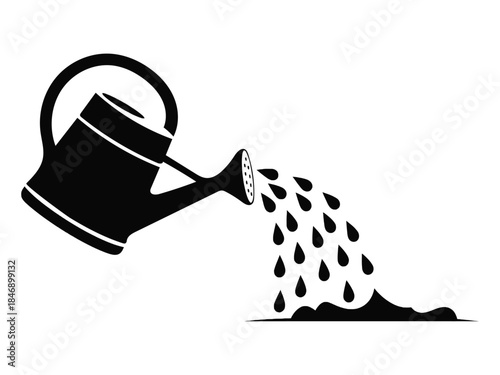 Watering can pouring water onto a dark patch of soil