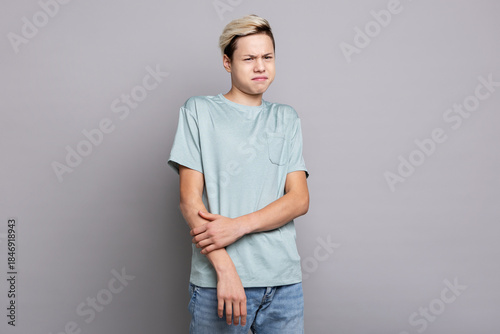 Bild auf Leinwand Teenage boy showing disgust and displeasure while reacting to something unpleasa