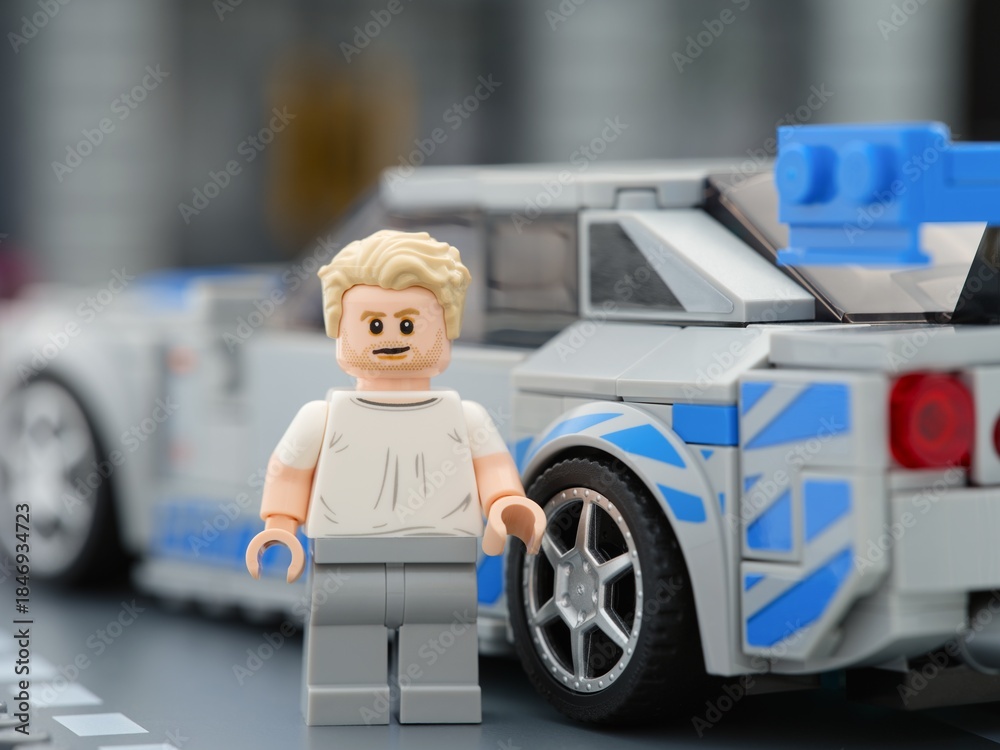 Naklejka premium Tambov, Russian Federation - August 21, 2025 Lego Speed Champions Nissan Skyline GT-R (R34) car and driver Brian OConner minifigure. 2 Fast 2 Furious movie.