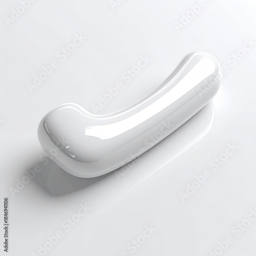 A smooth, glossy, white, curved, abstract shape on a pristine white surface