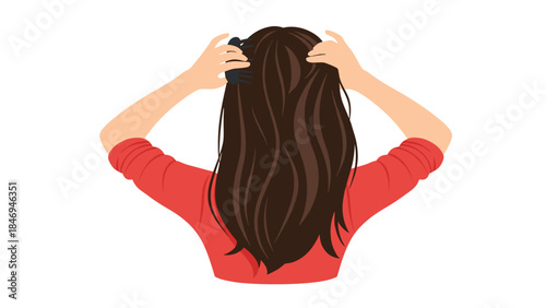 Woman with long brown hair using a hairbrush to style her locks from the back, demonstrating self-care and grooming practices.