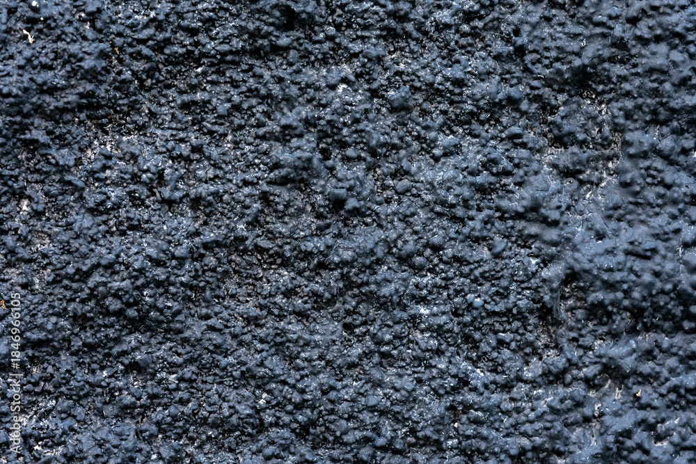 Obraz premium Abstract Dark Black and Navy Blue Gritty Wall Texture Background with Coarse Rough Surface, Industrial or Grunge Background: Seamless Pattern of Rough, Bumpy, and Weathered Texture
