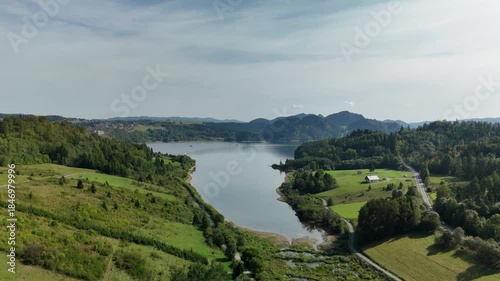Scenic Aerial View of Czorsztyn Lake and Cycling Route in Southern Poland with Mountains, Forests and Green Valleys