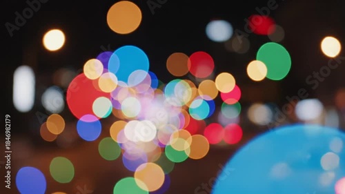 Abstract Bokeh Lights Colorful Circles of Red Blue Green Yellow Purple and White Illuminate a Dark Night Cityscape Background Creating a Festive and Dreamy Atmosphere Perfect for Celebrations