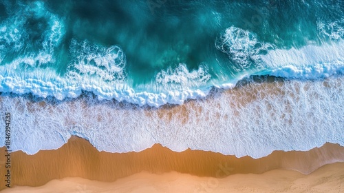 Top-down aerial view of turquoise ocean waves hitting sandy beach. AI-generated.