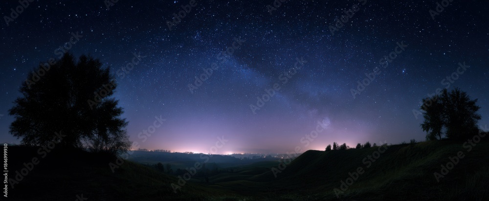 Fototapeta premium The evening sky packed with stars above a calm peaceful scene