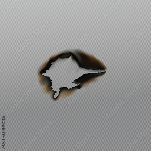 Small singed hole with dark brown burnt edges on a textured light gray background surface