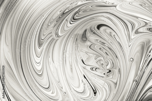 Mixing white and black liquid paint displaying an artistic flowing marble texture. Color of the Year Concept