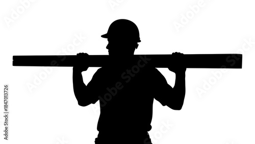 Construction Worker Silhouette: The strong silhouette of a construction worker carries a heavy beam. The image emphasizes labor and construction.