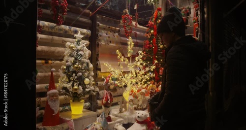 Woman looking at Christmas offers at a store