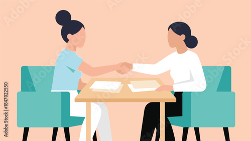 Business agreement: two professional women shaking hands at a table