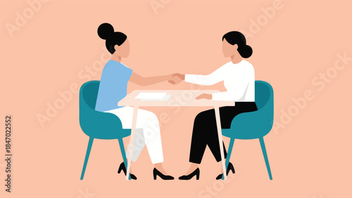 Two businesswomen shaking hands in a professional agreement or partnership