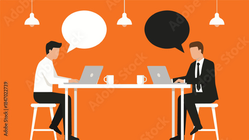 Two businessmen communicating and collaborating on laptops at a table