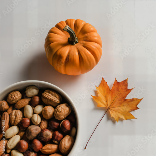 Wallpaper Mural "Autumn Still Life with Small Pumpkin, Mixed Nuts Bowl and Maple Leaf on White Table — Harvest Snack and Fall Mood" Torontodigital.ca