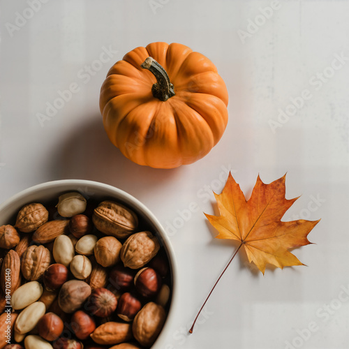 Wallpaper Mural "Autumn Still Life with Small Pumpkin, Mixed Nuts Bowl and Maple Leaf on White Table — Harvest Snack and Fall Mood" Torontodigital.ca