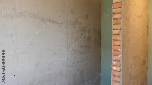 Room undergoes major renovation with covered walls and floors and scattered painting tools, illustrating home improvement project. Home reconstruction concept. result of finishing plastering drywall