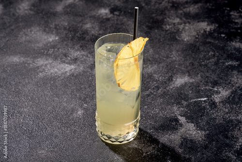 Photos The cocktail is served in a textured, cut-glass highball or collins glass