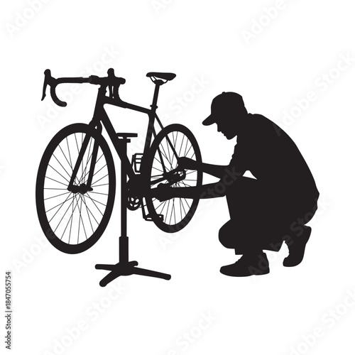 Silhouette of a cyclist repairing a road bike with a toolkit
