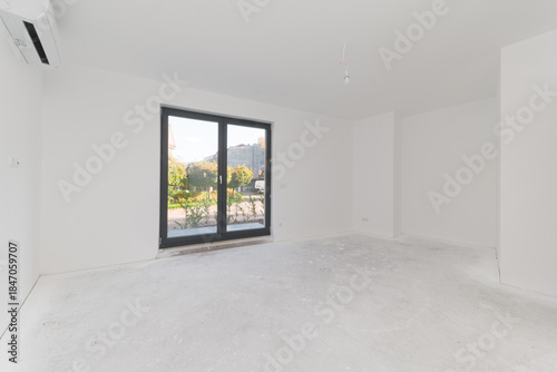 Bright empty room interior with white walls and air conditioner