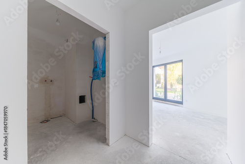 Unfinished apartment interior with hallway and room view