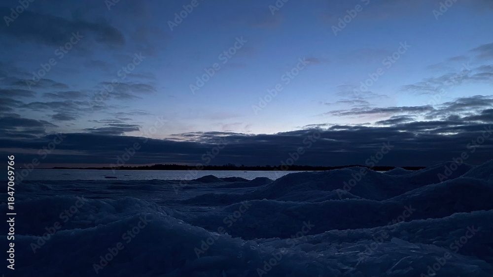 Fototapeta premium Calm frozen sea at winter sunrise