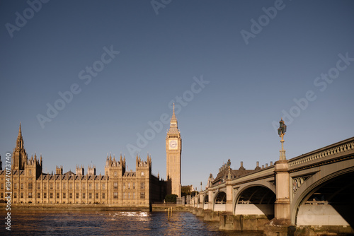 The houses of parliament with Big Ben, Elizabeth Tower and Westminster bridge at sunset.