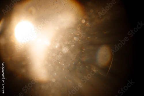 Lens Flare. Light over black background. Easy to add overlay or screen filter over photos. Abstract sun burst with digital lens flare background. Gleams rounded and hexagonal shapes, rainbow halo. big