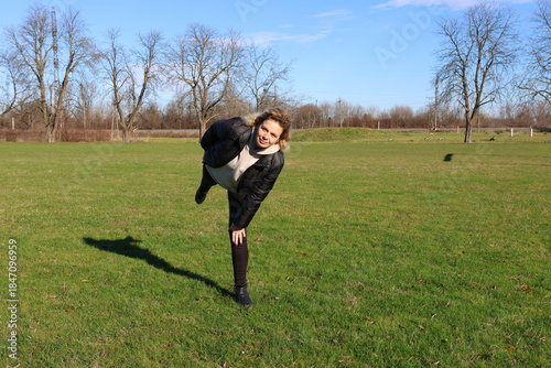 Woman doing morning exercises on an outdoor sports ground