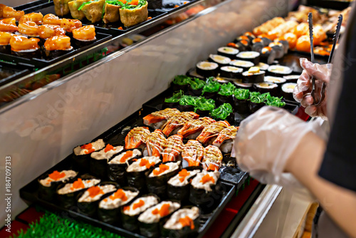 Colorful sushi platter featuring variety of sushi types, including rolls and garnishes, arranged neatly on serving tray, showcasing vibrant colors and textures of ingredients