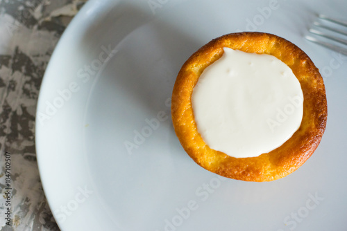 Delicious cheesecake with sour cream on a plate. Breakfast concept for the family