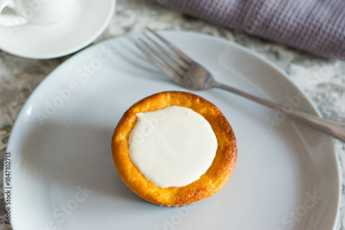 Delicious cheesecake with sour cream on a plate. Breakfast concept for the family