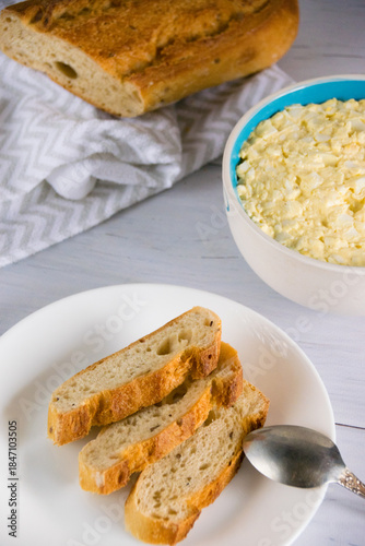 Whole grain baguette made from buckwheat flour and sesame seeds, and salad with egg