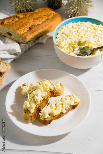 The process of preparing for the Christmas and New Year holidays. Making sandwiches with baguette, processed cheese and egg