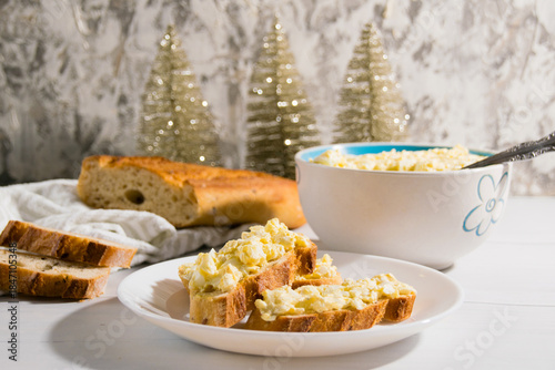 The process of preparing for the Christmas and New Year holidays. Making sandwiches with baguette, processed cheese and egg