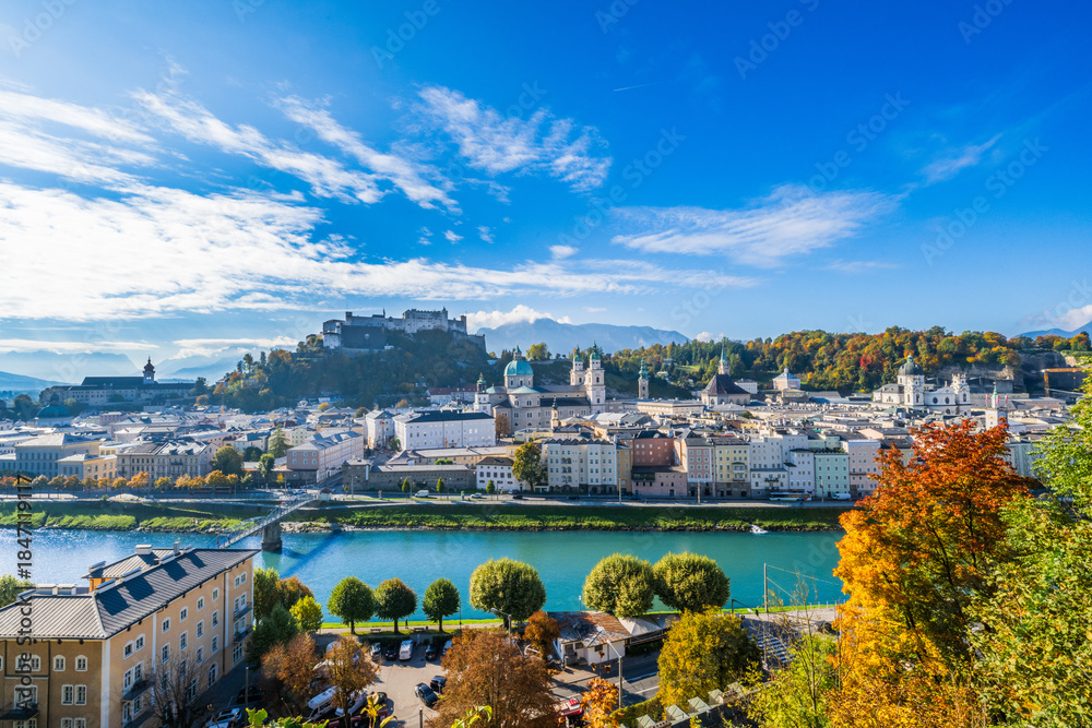 Fototapeta premium City of Salzburg with Salzach River and Fortress Hochensalzburg in the fall season.