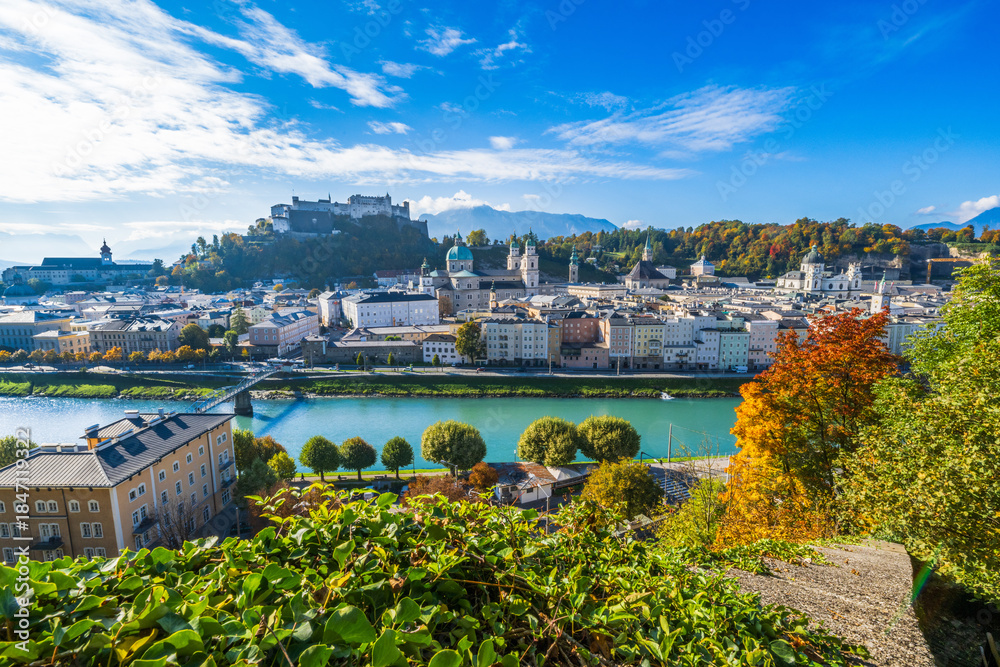 Fototapeta premium City of Salzburg with Salzach River and Fortress Hochensalzburg in the fall season.