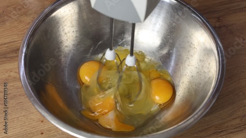 beating eggs with a mixer, stirring with an electric appliance