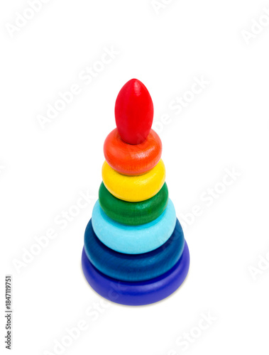 Multicolored wooden toy pyramid on white  background. Toy, build from colored wooden rings. Kids educational toy set, colorful blocks