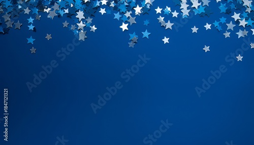 Blue abstract Christmas background or texture with stars confetti on blue background. Space for text
