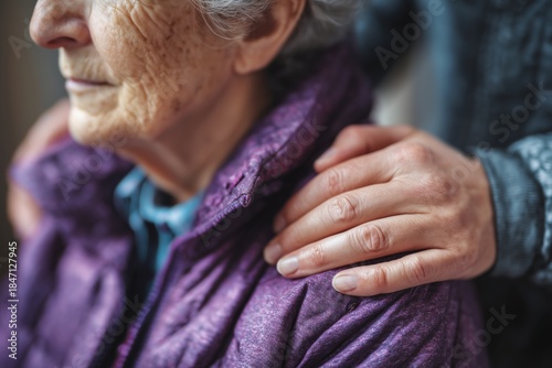 Caregiver's Hand Gently Resting on an Elderly Woman's Shoulder