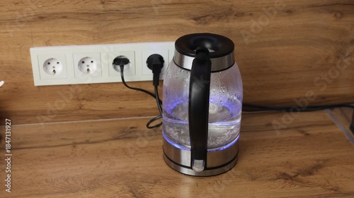 glass electric kettle boiling water in the kitchen