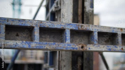 Construction workers carrying concrete formwork on site