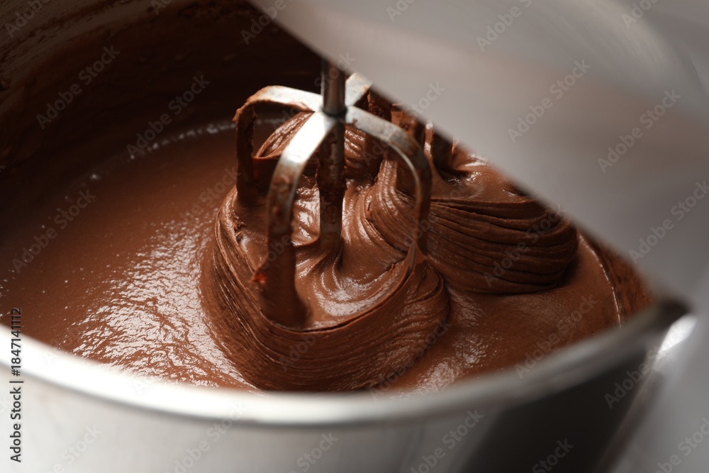 Fototapeta premium Mixing chocolate dough in bowl, closeup view
