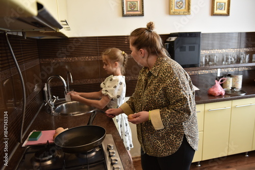 Mother and young daughter washing hands at kitchen sink before cooking together, child learning hygiene and helping parent prepare homemade breakfast, family routine, parenting, cozy home lifestyle
